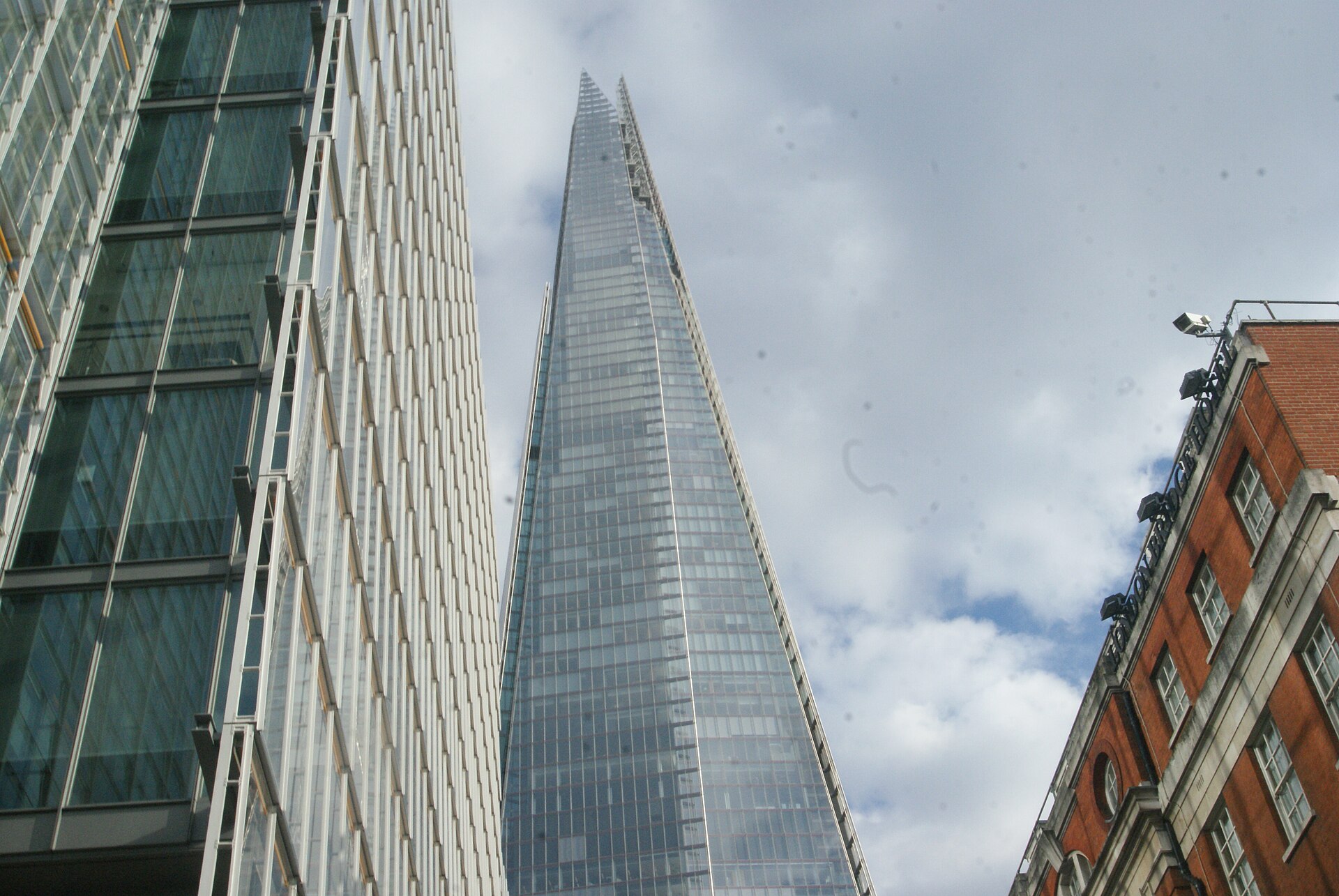 The Shard seen from London Bridge Street, between neighbouring office buildings